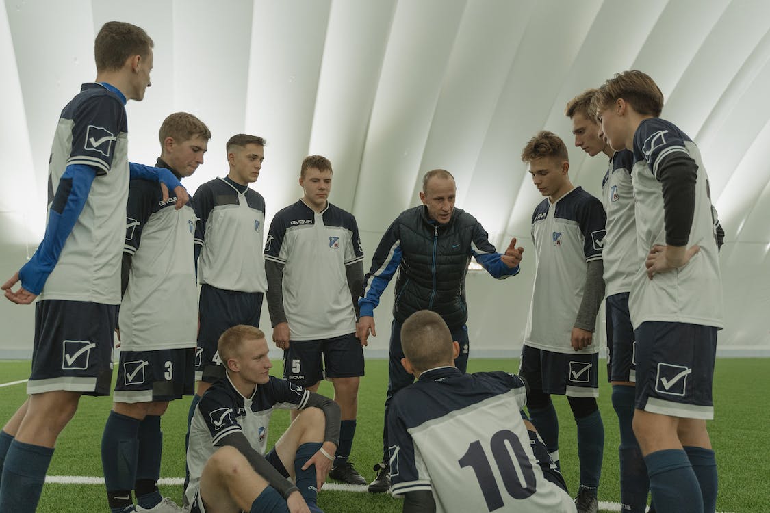 Players talking with coach in circle